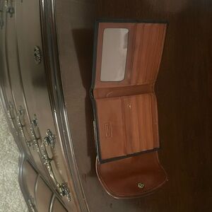 Wallet Dooney and Burke Black with brown border - condition fair .has slots